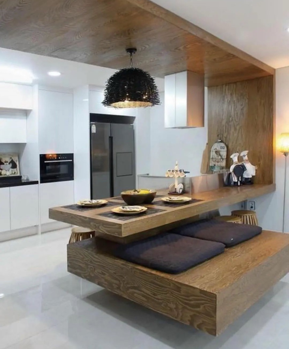 Modern kitchen with floating wood island and built-in bench seating