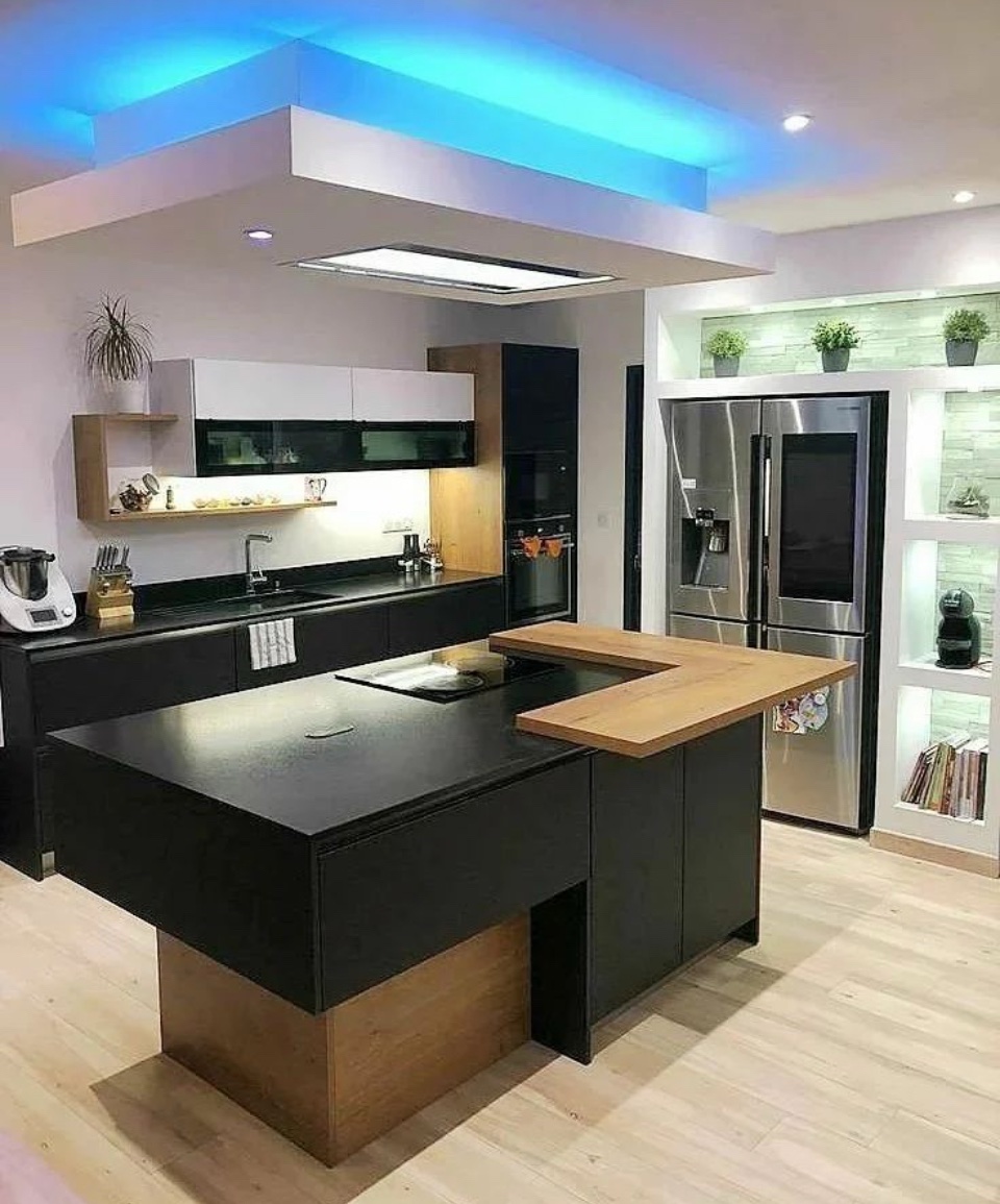 Modern kitchen with black island, wood breakfast bar and blue LED ceiling